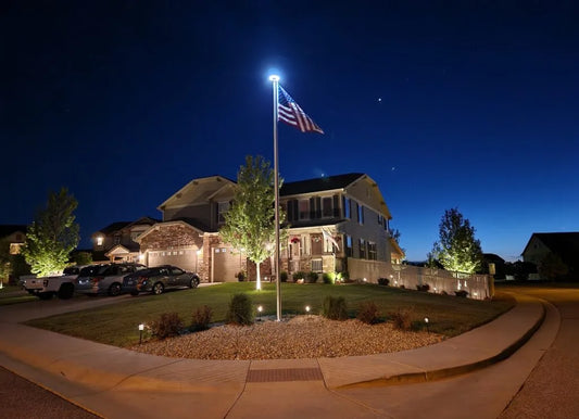 Solar light illuminating an American flag display on a residential flagpole